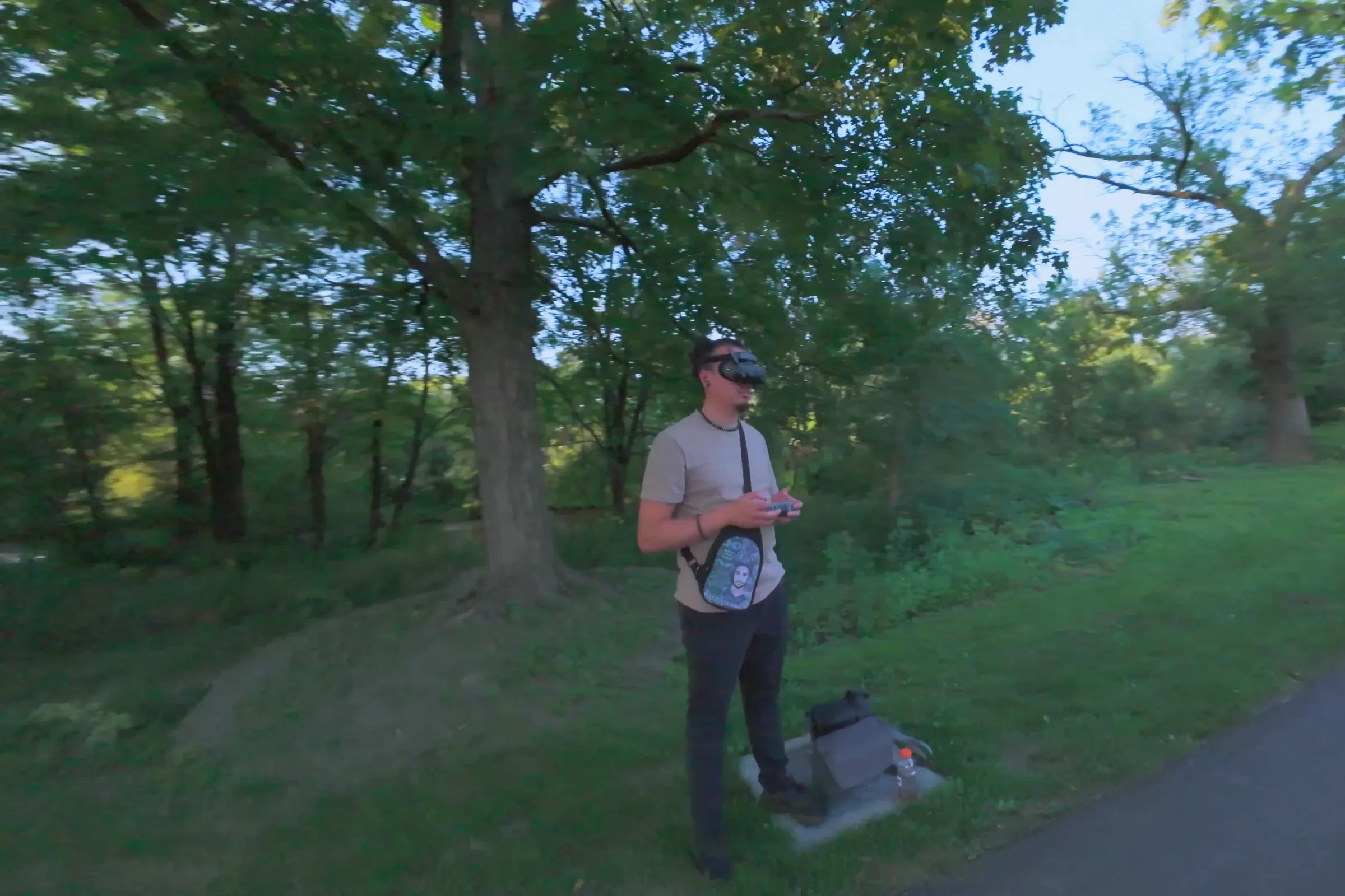 Drone pilot flying with FPV goggles and a controller in a Lehigh Valley park